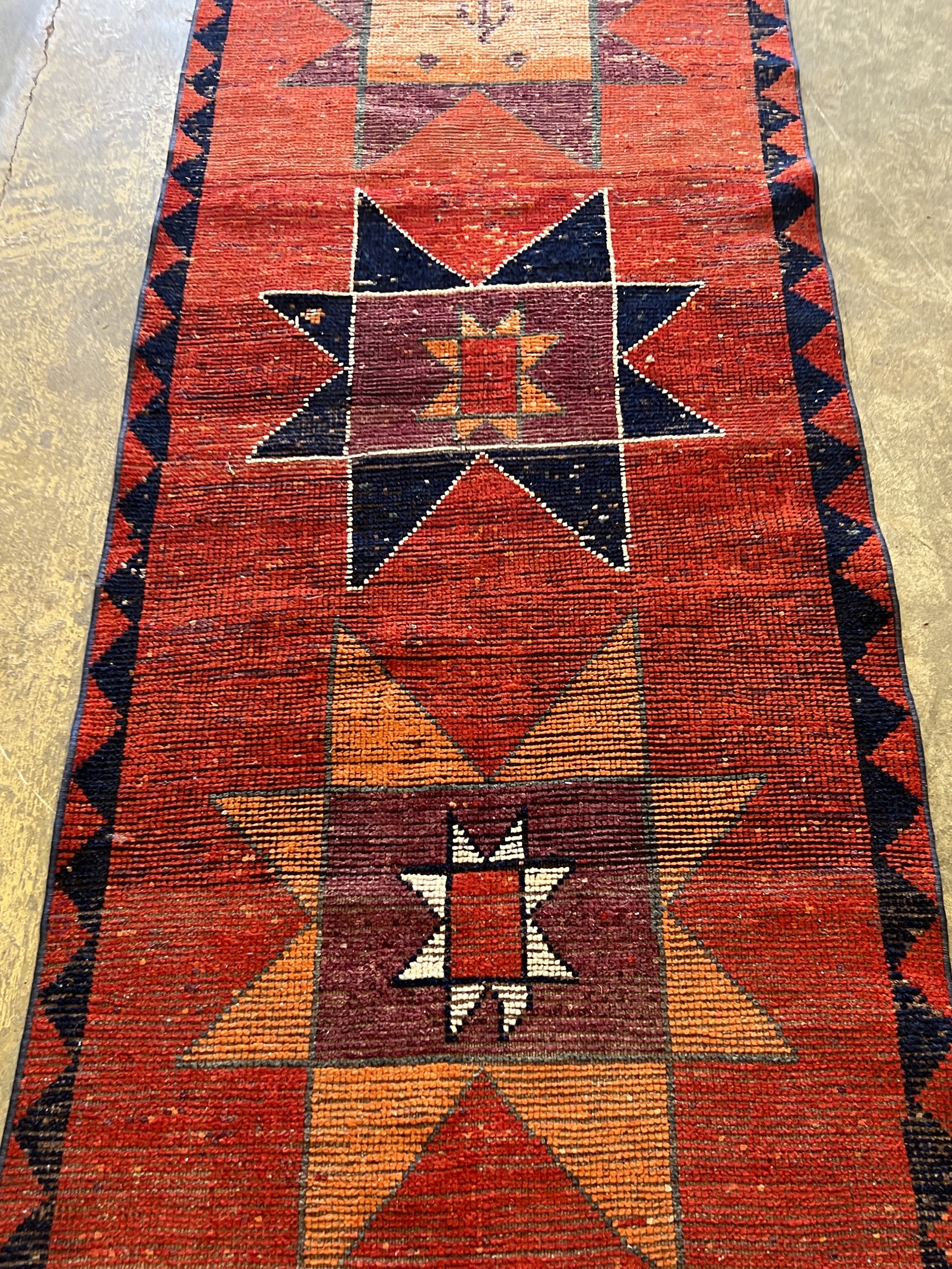 A Turkish red ground geometric runner, 298 x 87cm
